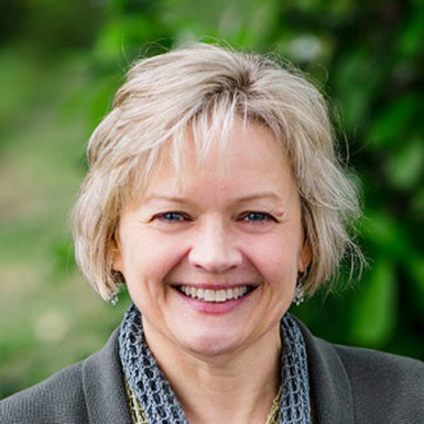 blonde woman smiling, short wavy hair